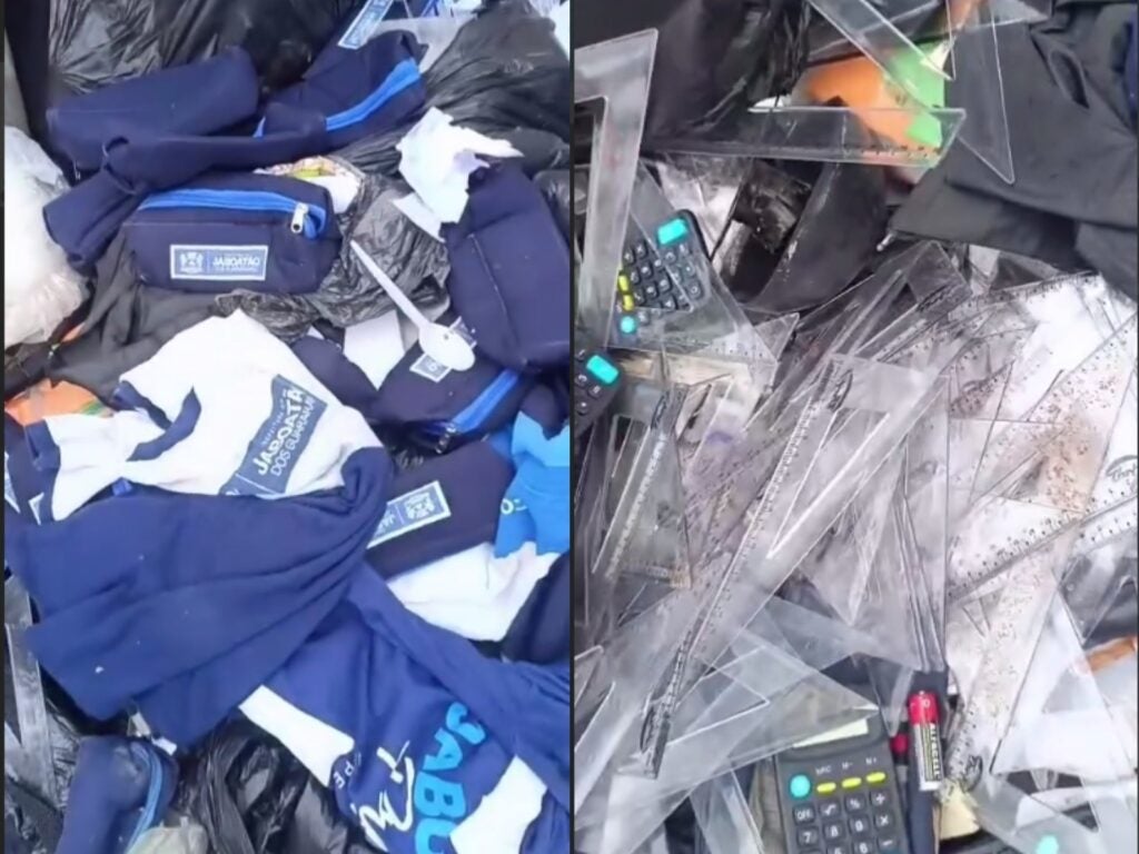 Material escolar e uniformes em bom estado são descartados em área de lixo, em Jaboatão